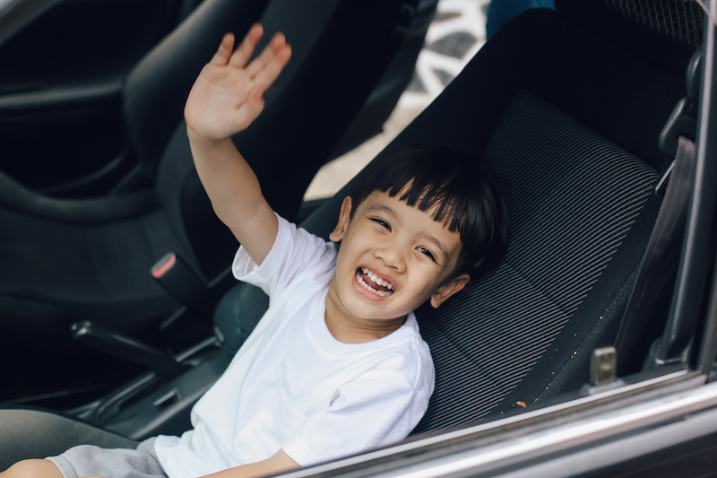 Little boy waving