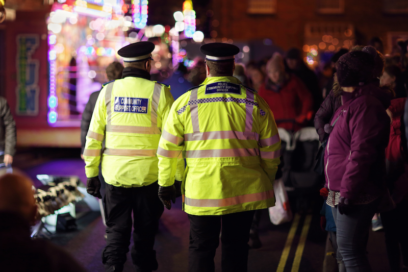 Police in hi-visibility jackets policing crowd control at a UK event