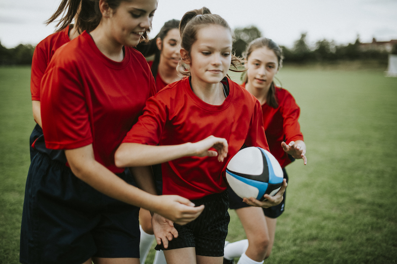 Female rugby players in action on the field