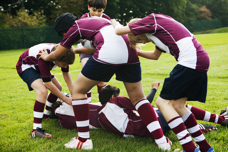 Teenage schoolboy rugby team playing aggressively