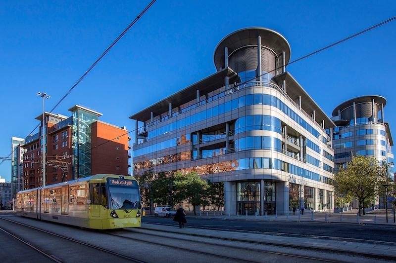 Modern buildings and tram system in the city of Manchester in northwest England.