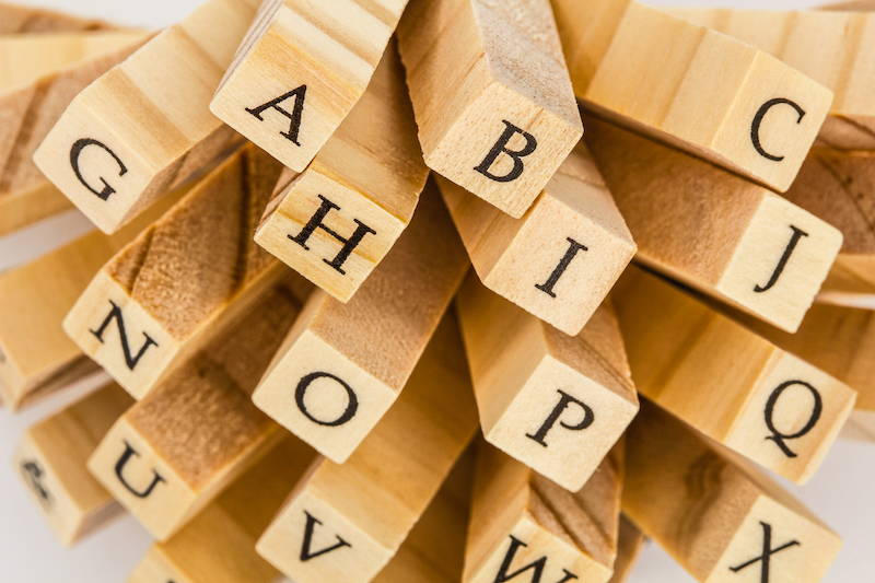 Letters of the English alphabet on the ends of wooden bars