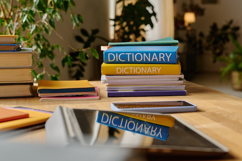 Colorful dictionaries and textbook on desk