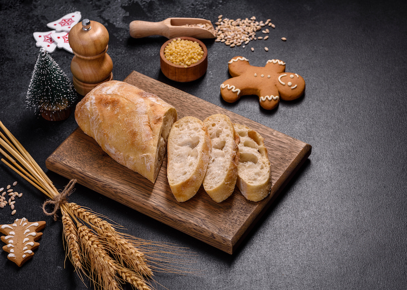 French baguette bread sliced on a wooden cutting board