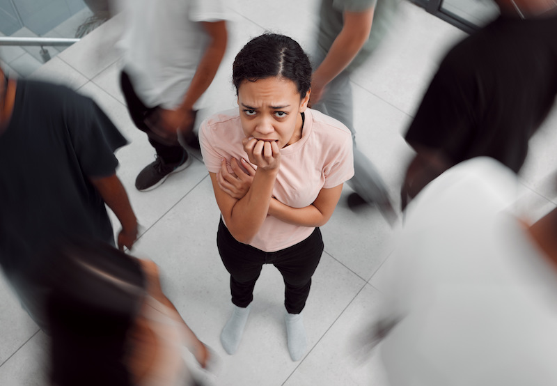 a scared young woman in a crowd