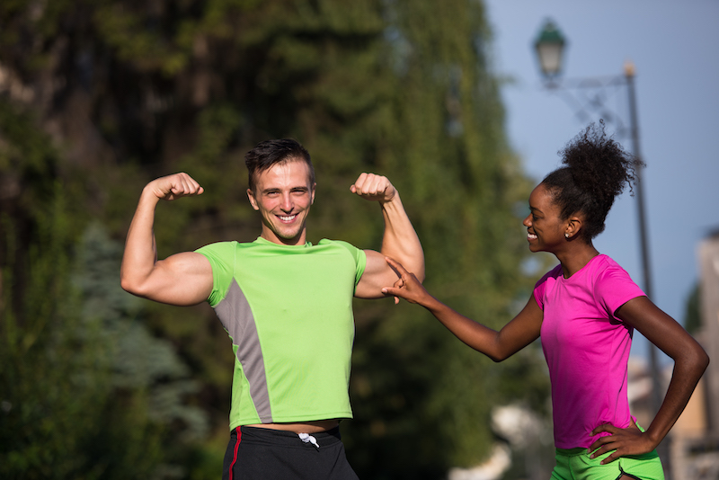 portrait of young multietnic jogging couple ready to run on fresh morning in the city