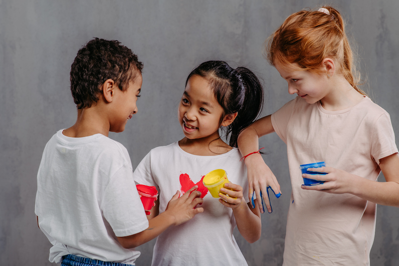 Portrait of happy kids with painted hands