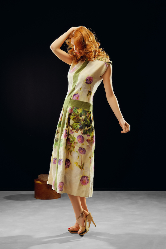 red hair model posing in fashion dress on black background