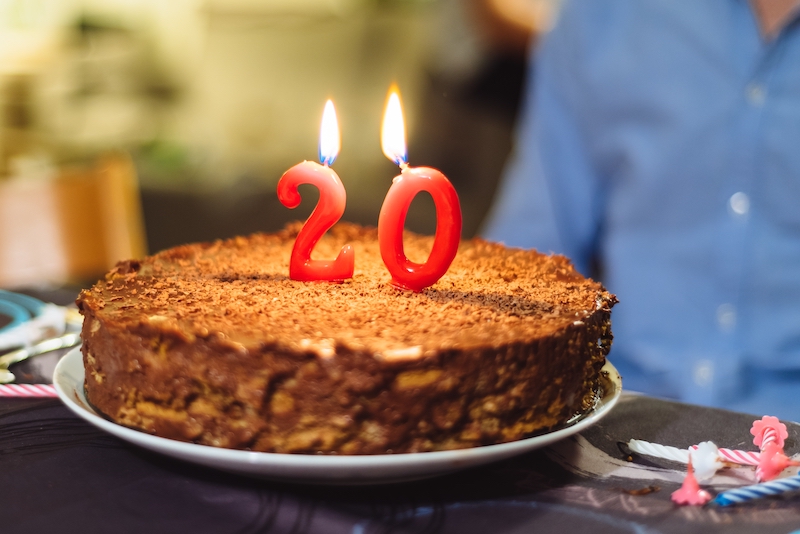 Number twenty candles on a homemade chocolate cake.
