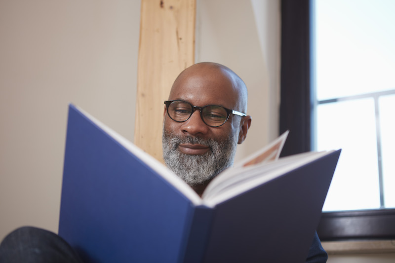 Portrait of man reading a book