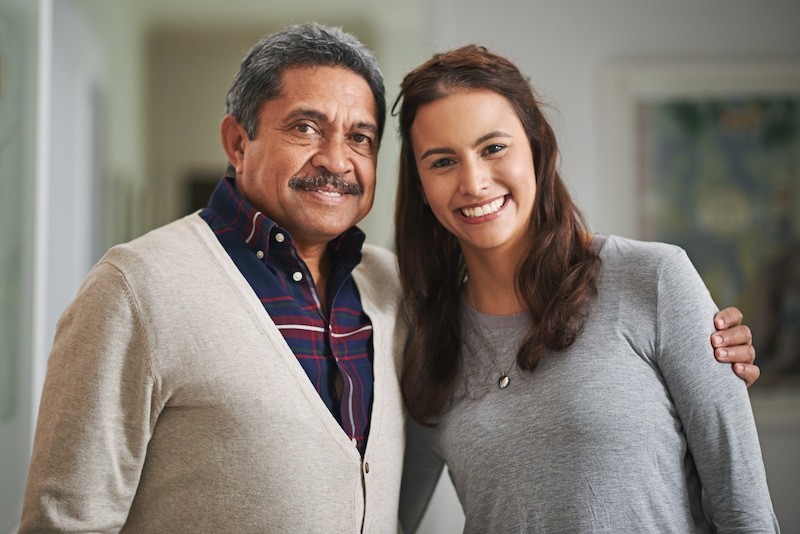Cropped portrait of a young woman and her mature father at home