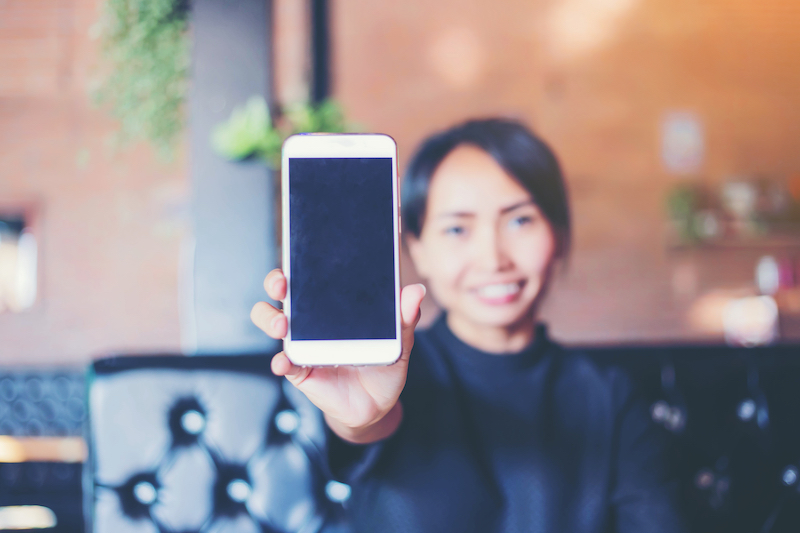 woman holding up a phone