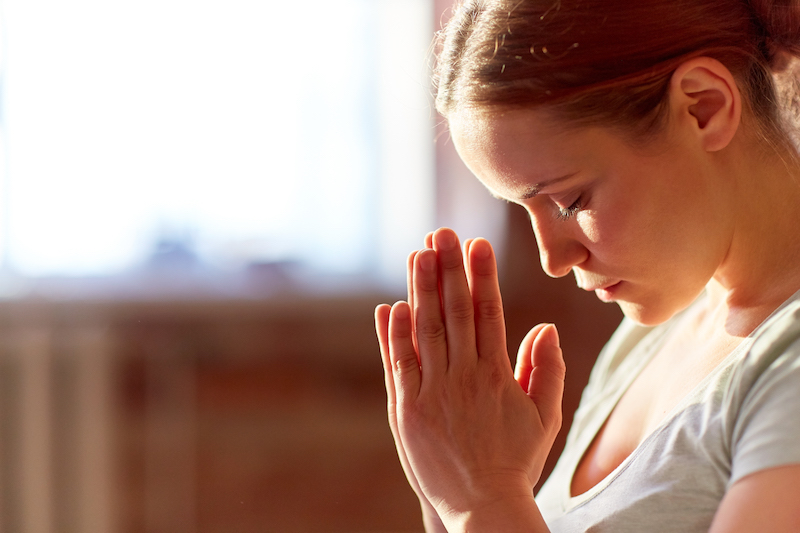 close up of woman meditating at yoga studio