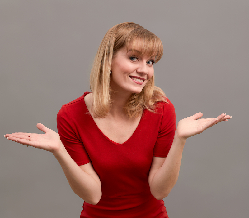 Happy surprised blonde young female smiling broadly at camera