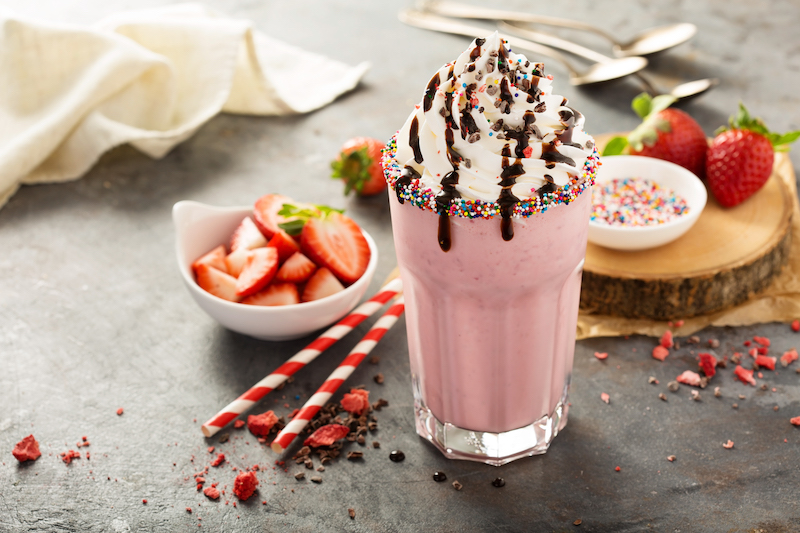 Strawberry milkshake with whipped cream and chocolate syrup