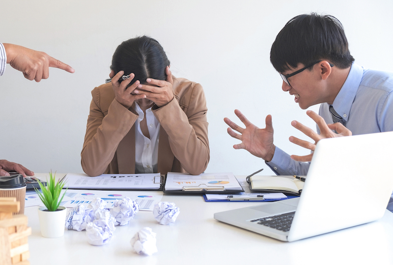 two male employees causing trouble for female employee