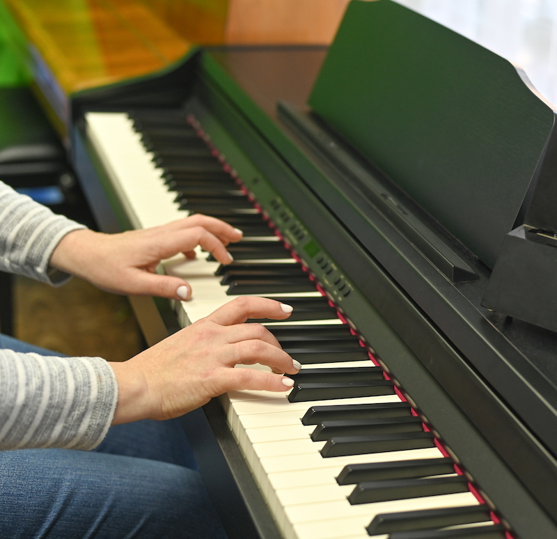 Woman playing electronic piano