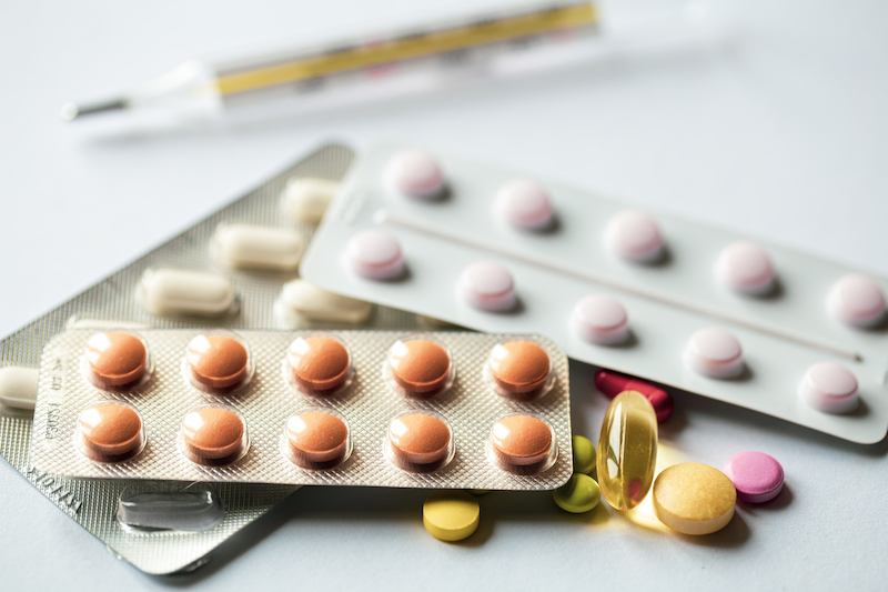 Assorted pills on white background